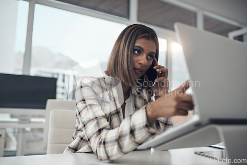 Image of Laptop, phone call and business woman pointing in office workplace, communication or chat. Computer, smartphone and Indian female professional reading email, discussion or conversation with contact.