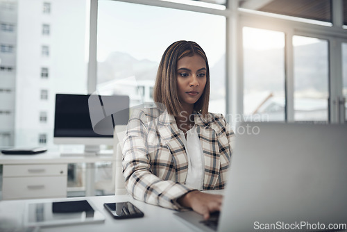 Image of Business woman, laptop and writer typing in office workplace. Copywriting, computer and female Indian person reading, work or writing email, focus on report or proposal, research or planning project