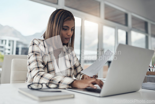Image of Business analyst, laptop and woman typing documents in office workplace. Paperwork analysis, computer and female Indian person reading analytics for data, graphs or charts for finance statistics.