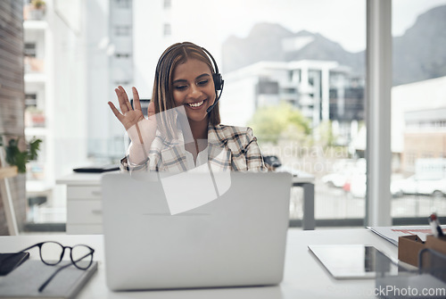 Image of Business woman, headset and laptop for a video call and hand to wave hello on webinar with internet. Female person with technology for communication, online meeting and customer support in an office