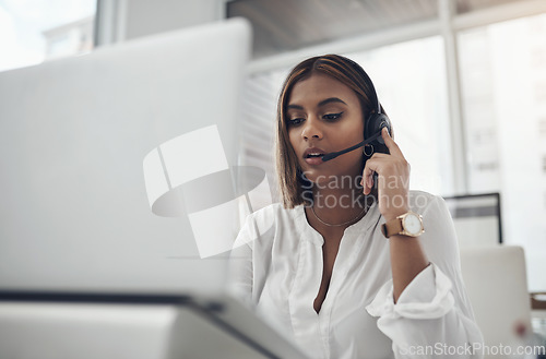 Image of Laptop, headset and a woman in call center for customer service, telemarketing or help desk. Female person, consultant or agent with technology for contact us, telecom support or crm at a company