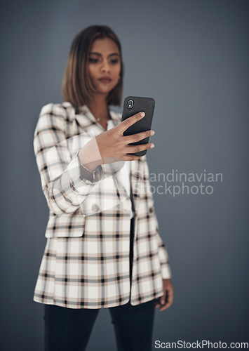 Image of Young business woman, selfie and fashion by wall background with pride, career or creativity on social media app. Indian businesswoman, photography and influencer with profile picture, post or blog