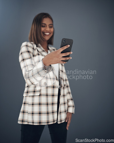 Image of Young business woman, selfie and smile by wall background with fashion, happiness and creativity on social media app. Indian businesswoman, photography and profile picture with pride, happy and blog