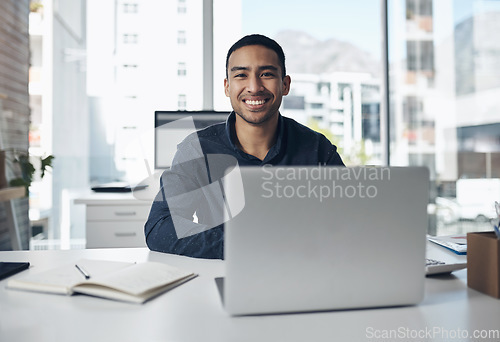 Image of Portrait, laptop and a professional editor man at work in a journalism agency for news reporting. Computer, smile and online content with a happy male journalist working in a modern editing office