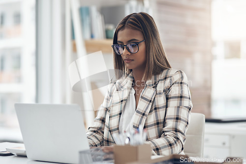 Image of Laptop, copywriter and business woman typing in office workplace. Writer, computer and female Indian person reading, working and writing email, report or proposal, research online or planning project