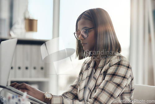 Image of Laptop, editor and business woman typing in office workplace. Writer, computer and female Indian person reading, working or writing email, report or proposal, research online or planning project.