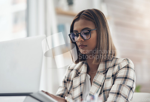 Image of Copywriting, laptop and business woman typing in office workplace. Writer, computer and female Indian person reading, working or writing email, report or proposal, research online or planning project