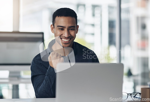 Image of Young business man, celebrate and laptop with smile, winning or success on stock market in office. Indian businessman, computer and winner with fist celebration, profit and bonus in online gambling