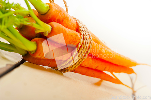 Image of baby carrots bunch tied with rope