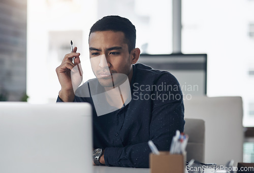 Image of Laptop, thinking and reading with a man journalist working in his office for editing a news report or article. Computer, idea and online with a young male editor at work in a modern journalism agency