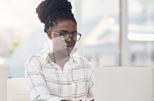 Image of Laptop, seo and focus with a black woman editor working in her office for online content or digital logistics. Computer, editing and feedback review with a young female journalist at work on a report