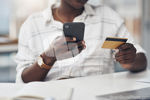 Image of Business woman, phone and credit card in hands for online shopping, e commerce and banking. African person at a desk with a mobile phone for fintech website, bill payment or money transfer in office