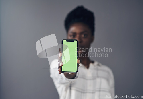 Image of Green screen, phone and woman in portrait isolated on a studio background for advertising space or mockup. Online mock up, show and african person with social media, networking or marketing design