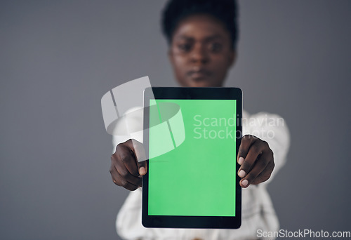 Image of Green screen, tablet and woman in portrait isolated on a studio background for advertising space or mockup. Online mock up, website design and african person with digital technology and application