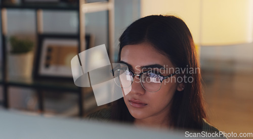 Image of Computer, night and face with a woman journalist working in her office for editing a news report. Focus, editing and reporting with a young female editor at work on a desktop for online content