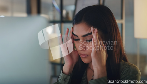 Image of Business woman, headache and computer at night in office with anxiety, stress or crisis. Female entrepreneur at a desk with tech while tired or depressed about deadline, mistake or internet problem