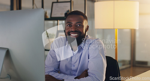 Image of Black man, business and portrait in night, office and smile with computer, pride and arms crossed. African businessman, auditor or entrepreneur in overtime with pc, finance or happy in dark workplace