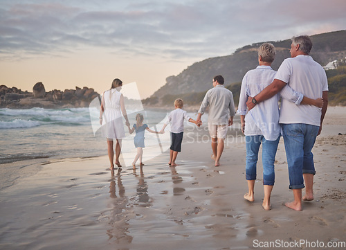Image of Family, generations and back with walking, beach and sunset with men, women and children with love. Parents, grandparents and kids by ocean, holding hands and bond on summer vacation with solidarity