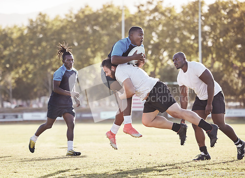 Image of Sports action, rugby and men on field for match, practice and game in tournament or competition. Fitness, teamwork and players tackle for exercise, training and performance for winning ball to score