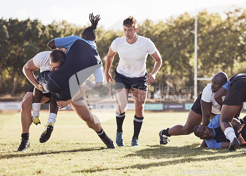 Image of Rugby, sports and men tackle for ball on field for match, practice and game in tournament or competition. Fitness, teamwork and players playing on grass for exercise, training and performance to win