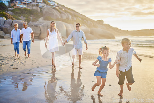 Image of Family, generations and kids with running, beach and sunset with men, women and happiness with love. Parents, grandparents and children by ocean, holding hands or bond on summer vacation with smile