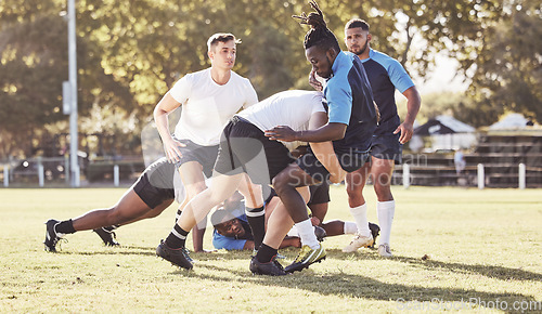 Image of Fitness, rugby and men in tackle on field for match, practice and game in tournament or competition. Sports, teamwork and group of players playing for exercise, training and performance to win ball