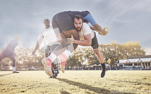 Image of Sports, rugby and men tackle for ball on field for match, practice and game in tournament or competition. Fitness, teamwork and sport players playing for exercise, training and performance to win