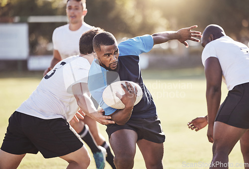 Image of Sports, rugby and men running on field for match, practice and game in tournament or competition. Fitness, teamwork and group of players tackle for exercise, training and performance to win ball