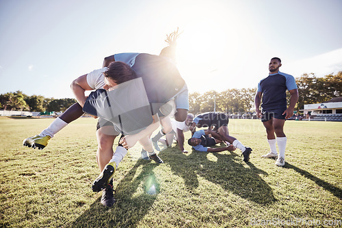 Image of Sports, rugby and men tackle on grass for match, practice and game in tournament or competition. Fitness, teamwork and players playing for exercise, training and performance to win ball on field