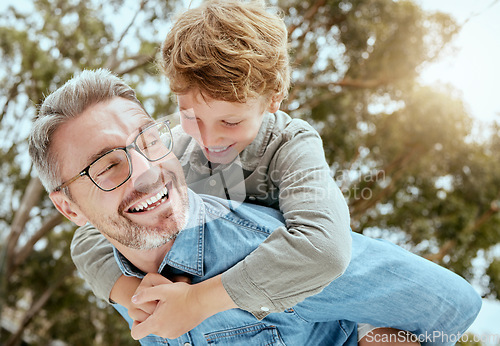 Image of Piggyback, fun and father with child in a park happy, playing and having fun in nature. Hug, love and parent carrying son in a garden, laughing and enjoying games, smile and together on the weekend