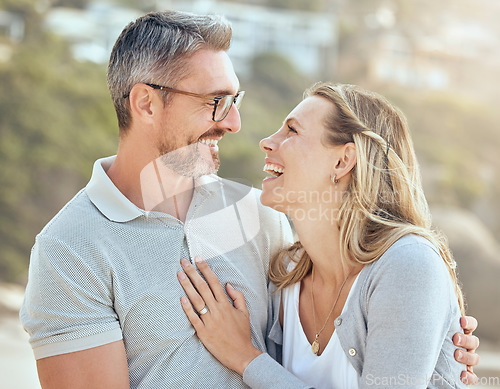 Image of Happy, smile and love with couple at beach for laughing, travel and summer vacation. Happiness, holiday and romance with man and woman hugging on seaside date for bonding, affectionate and care