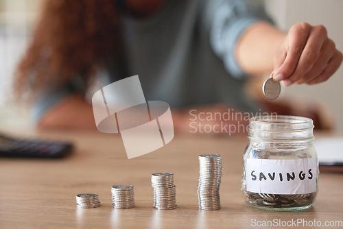 Image of Hand, savings jar and money with finance and budget, future financial planning with investment and coins on a table. Woman saving, payment and economy, growth and development, cash in glass container