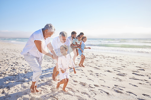 Image of Vacation, travel and big family running on the beach for playing, bonding and spending quality time. Happy, excited and children having fun with their grandparents and parents by the ocean on holiday