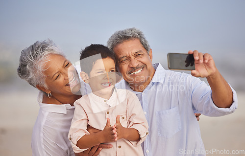 Image of Selfie, happy and grandparents with child at beach for vacation, bonding and generations. Picture, travel and young boy with senior man and woman in nature for smile, happiness and technology