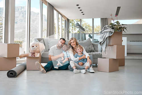 Image of Moving, box and portrait of family in new house for property, investment or future. Real estate, happy and renting with parents and children in living room of home for relocation, homeowner and relax