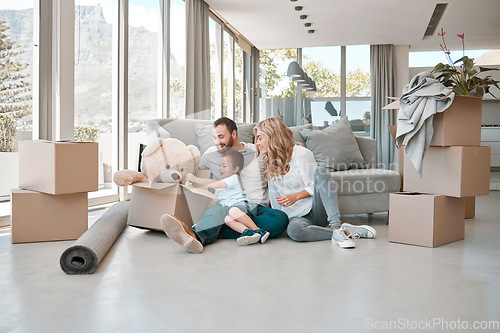 Image of Moving, box and teddy bear with family in new house for property, investment or future. Real estate, happy and renting with parents and baby in living room of home for relocation, homeowner and relax