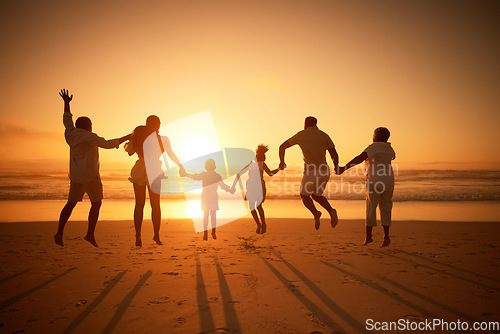 Image of Family, holding hands beach at sunset and jump, freedom and travel with grandparents, parents and kids. Back view, orange sky and generations and people outdoor with silhouette and vacation in Mexico