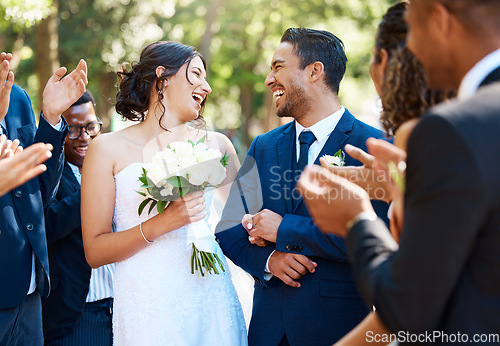 Image of Wedding ceremony, couple and people clapping hands in celebration of love, romance and union. Happy, smile and bride with bouquet and groom walking by guests cheering for marriage at an outdoor event