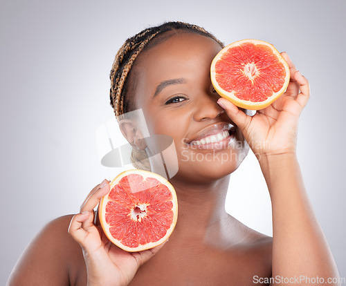 Image of Beauty, grapefruit and portrait of black woman in studio for natural, cosmetics and vitamin c. Nutrition, diet and detox with female model on grey background for citrus fruit and health product