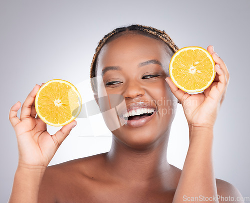 Image of Beauty, orange and skincare with black woman in studio for natural, cosmetics and vitamin c. Nutrition, diet and detox with face of female model on grey background for citrus fruit and health product