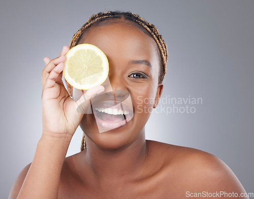 Image of Beauty, lemon and smile with portrait of with black woman in studio for natural, cosmetics and vitamin c. Nutrition, diet and detox with model on grey background for citrus fruit and health product