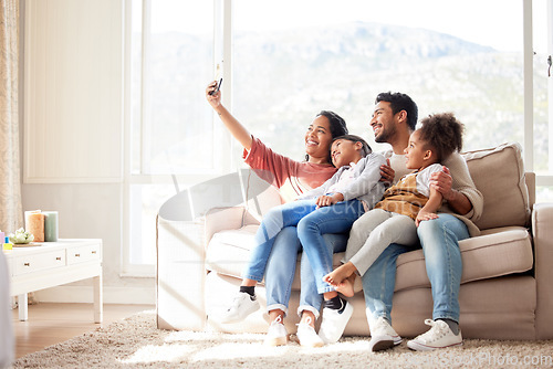 Image of Parents, children and sofa selfie with smile, happiness and bond in lounge for social media app. Father, mother and daughters with care, love and together for profile picture, blog and happy on couch