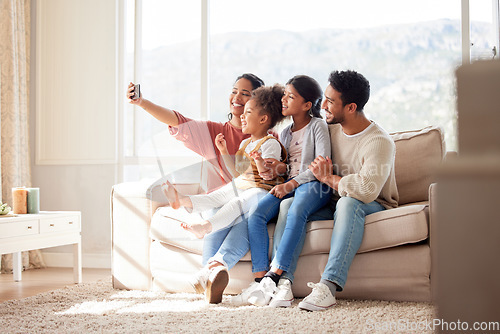 Image of Parents, children and couch selfie with smile, happiness and bond in lounge for social media app. Father, mother and daughters with care, love and together for profile picture, blog and happy on sofa