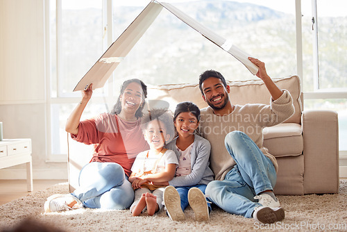 Image of Parents, floor and cardboard roof for kids, portrait or sign of safety, security or family home with bond in lounge. Father, mother and daughters with box, love or together for icon, emoji and smile