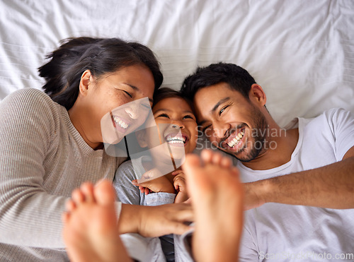 Image of Fun, bed and happy family playing, wake up and happy from above, tickle and laughing in their home. Bedroom, games and girl with parents, smile and laugh, relax and love in their house on the weekend