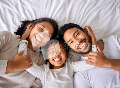 Image of Love, selfie and family in bed from above happy, smile and bonding in their home together. Portrait, girl child and top view of parents with their daughter in a bedroom, relax and embracing indoors