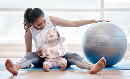 Image of Woman, happy baby and floor with exercise ball, laughing and bonding together with fitness, health and wellness. Workout, mother and daughter with happiness, home and excited face for training in gym