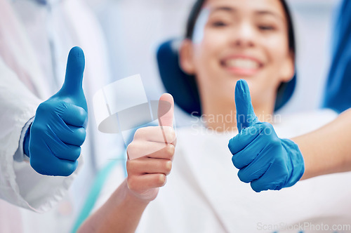 Image of Dentist, thumbs up and happy patient in consultation for teeth whitening, service and dental care. Healthcare, dentistry and hand sign of orthodontist and woman for oral hygiene, wellness or cleaning