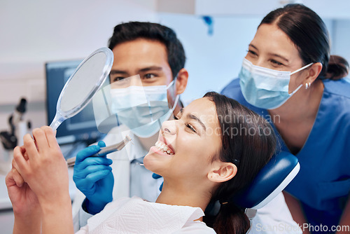 Image of Dentist, mirror and woman with smile in consultation for teeth whitening, service and dental care. Healthcare, dentistry and female patient with orthodontist for oral hygiene, wellness and cleaning