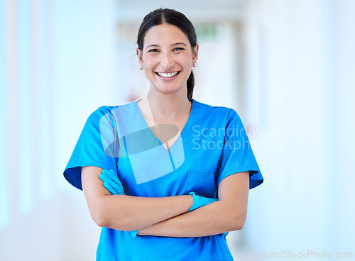 Image of Woman, nurse and portrait with arms crossed and smile in a hospital and clinic. Employee, healthcare and wellness professional with happiness and confidence from doctor and medical work and care